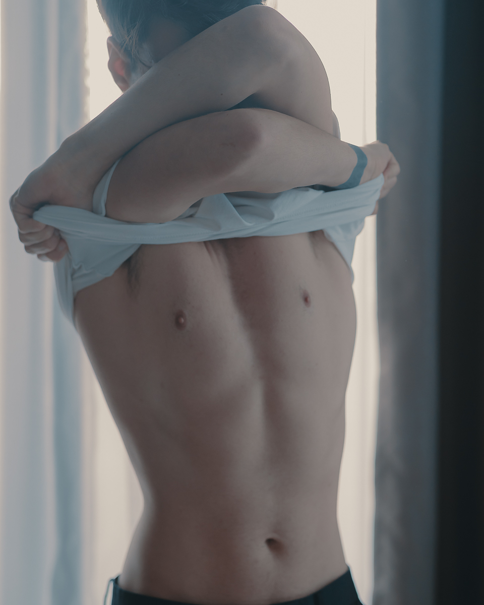 portrait of zaccy taking off his shirt